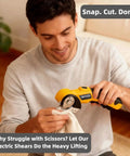 Cordless Electric Scissors With Led Light And Safety Lock Cuts Cardboard Fabric Carpet Plastic And Leather Without One Bit Of Drama used by a man cutting fabric.