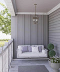 Burlington Two-Light Hanging Lantern In Oil Rubbed Bronze Finish on porch with swing, classic farmhouse style, outdoor view