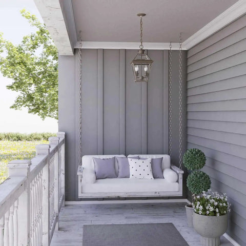Burlington Two-Light Hanging Lantern In Oil Rubbed Bronze Finish on porch with swing, classic farmhouse style, outdoor view
