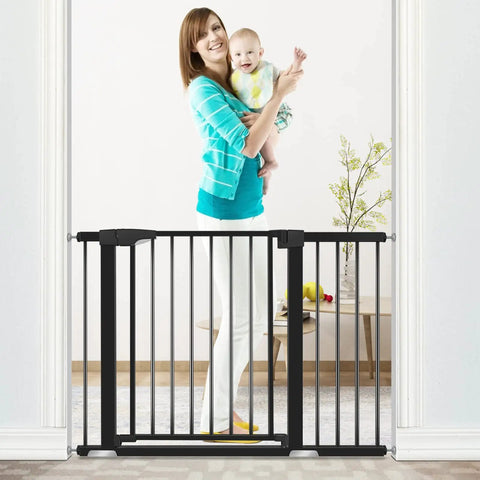 Adjustable Baby Gate For Stairs And Doorways, 30 Inches Tall, black gate installed in doorway, woman holding baby behind gate.