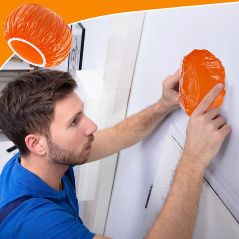 Person fitting Orange 24 Piece Elastic Smoke Detector Covers For Cooking Or Baking Thickened Plastic Fire Alarm Shield onto device