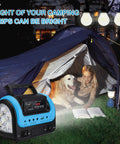 Beefy All In One Portable Solar Power Station With Panel And Built-In LED Lights next to a tent with a girl and dog at night