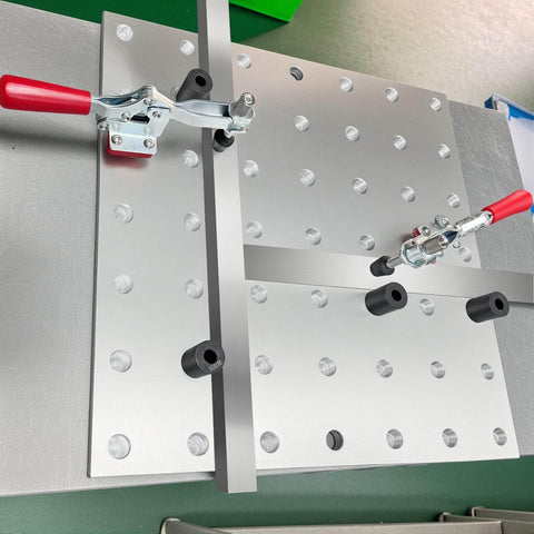 5/8 Inch Insert Clamp Fixture for Welding Tables on benchtop with quick press and sliding jaws, mounted on right angle bracket