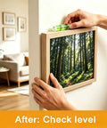 Person using a level on a wall-mounted picture frame in a living room setting with plastic drywall anchors.