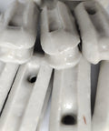 Close-up of glazed ceramic antenna insulators, 22 pack, small ceramic isolators for dipole, inverted Vee, end-fed antennas
