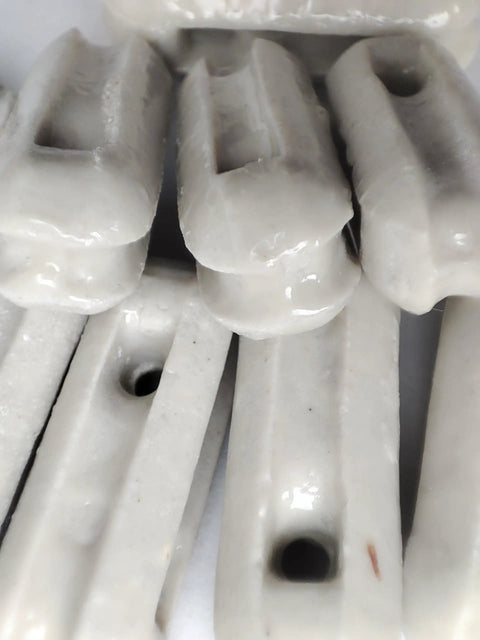 Close-up of glazed ceramic antenna insulators, 22 pack, small ceramic isolators for dipole, inverted Vee, end-fed antennas