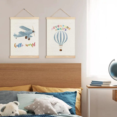 Epic Hot Air Balloon And Airplane Nursery Decor Set Of 2 Posters For Boys Room 12x16 Inch Baby Boy Wall Art With Built In Wooden Hanger Frame Perfect Nursery And Toddler Playroom Hanging Sign, featuring a blue airplane and hot air balloon above a child's bed.