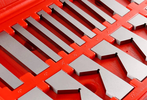 Close-up of 17-piece precision angle block set; gray metal blocks on a red storage tray