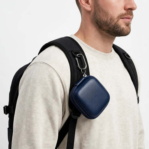 Dang Slick PU Leather And Eva Hard Shell Earbud Case For AirPods And Wireless Pods in blue attached to backpack with carabiner.