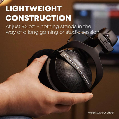 Person holding DT 770 PRO 80 Ohm Closed Back Over Ear Studio Headphones With 3M Straight Cable And Limited Edition Black Velour Ear Pads.