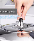 Front view of a stainless steel pressure cooker relief valve kit with exhaust rod being installed on a shiny lid; two-pack.
