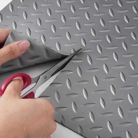 Heavy Duty Red PVC Garage Floor Mat Roll 1.5x2m Cuttable being cut with scissors