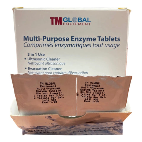 Open box of TM Global Multi-Purpose Enzyme Tablets with bilingual labeling for ultrasonic and evacuation cleaner use.