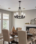 Dining room with Six Light Industrial Rustic Farmhouse Wagon Wheel Chandelier In Black Metal With Clear Glass Shades