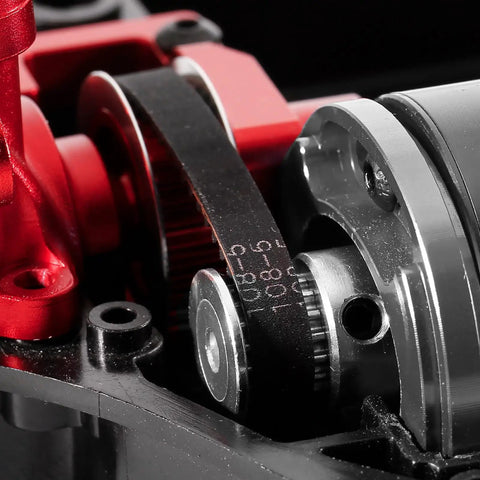 Close-up of Race-Grade TT02 Belt Drive RC Car Transmission System with 36T aluminum pulley and 16T gear, in red, installed.