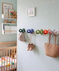 Set of Six Playful Ceramic Wall Hooks for Coats and Keys Game Changer Storage Solution in a children's room with decor.