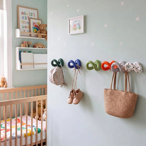 Set of Six Playful Ceramic Wall Hooks for Coats and Keys Game Changer Storage Solution in a children's room with decor.