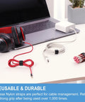 Go-To Half Inch By One Hundred Foot Hook And Loop Roll with self-gripping strips organizing cables on desk with laptop and pencils