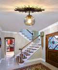 Sleek Black Flush Mount Ceiling Light With Glass Globe Sputnik Starburst 1 Light Close To Ceiling Fixture in a hallway.