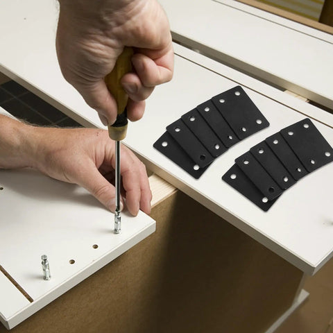Hand using a screwdriver with Heavy Duty Stainless Steel Furniture Brackets Set - 10 Straight Plate Brackets for furniture assembly