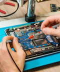 6000 Counts Digital Multimeter Auto Ranging TRMS With AC DC Voltage And Current in use for circuit testing on a blue mat