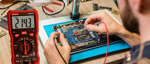 6000 Counts Digital Multimeter Auto Ranging TRMS With AC DC Voltage And Current in use for circuit testing on a blue mat