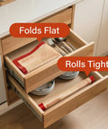Extra Thick Non Slip Silicone Baking Mat 32 By 24 Inch stored in kitchen drawer, folds flat and rolls tight, dual color markings visible.