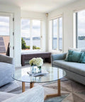 Modern living room with Round 29 Inch Clear Tempered Glass Table Top Replacement With Flat Polished Edge on wooden base.