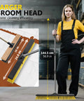 Heavy Duty 24.8 Inch Wide Push Broom With Dual Density Bristles Designed To Crush Gravel And Leaves On Driveways standing next to a woman.