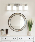 Four Light Brushed Nickel Vanity Light With Square Frosted Glass Modern Bathroom Wall Fixture Over Mirror E26 Sconce installed above a round mirror