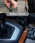 Top Shelf Crazy Horse Leather EDC Keychain Strap With Aerospace Titanium Key Ring For Car Keys held in hand and resting on console.