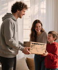 Family holding a box labeled 'Valvosport Soccer Goals,' possibly containing Portable Pop Up Soccer Goals Set For Backyard Play
