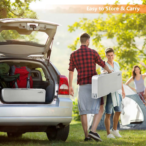 Two people carrying a folded 4 Ft Folding Camping Picnic Table Set With Seats And Umbrella Hole, Grab-And-Go Suitcase-Style Lightweight Aluminum Alloy Frame Table For RVs near a car.