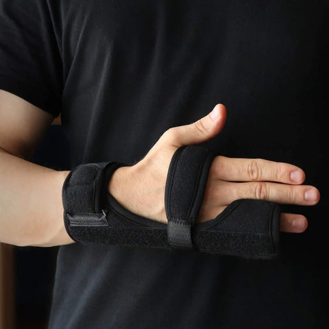 Person wearing Breathable Neoprene Metacarpal Splint For Both Hands Adjustable Left Or Right Finger Support on left hand