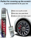 Gunpowder Gray Wheel Touch Up Paint Pen For Tesla Model Y And 3 S X Alloy Rims next to a wheel, showing the fine brush applicator.