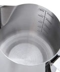 Interior view of stainless steel milk frothing pitcher with measurement markings, 12-ounce capacity, nonstick coated