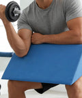 Person using Preacher Curl Pad With Non Slip Base For Home Gym Arm Support 16x8 Inch Cushion High Density Foam Angled Design