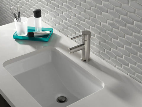 Modern Brushed Nickel Single Hole Bathroom Faucet With Single Handle And Drain Assembly Included, Easy Install Fits 4 Inch 3 Hole Config, Lifetime Warranty, Stainless 559LF-SSPP on white sink with light gray tile backsplash