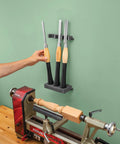 Grab And Go Pro Grade Wall Mounted Tool Organizer with Rare Earth Magnets holds chisels above a woodworking lathe