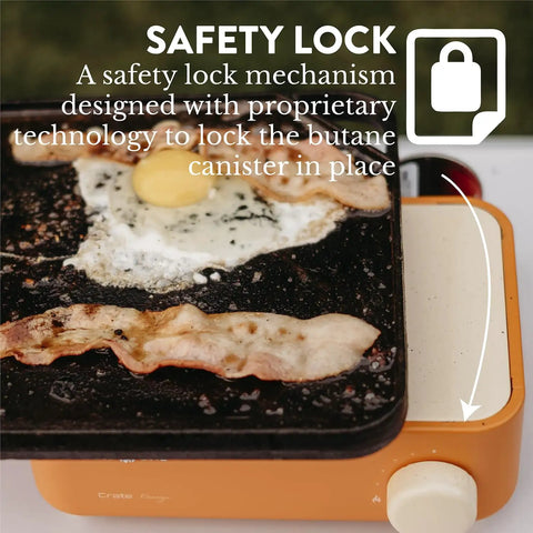 Butane Camp Stove For Hiking And Camping From The Crate Series, shows orange stove with safety lock holding a bacon and egg breakfast.