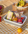 Collapsible Dish Pan 10L Folding Sink Basin for Dishwashing Camping RV and Vegetable Cleaning with snacks on picnic table