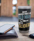 Sailplane Pilot Insulated Stainless Steel Tumbler For Glider Club Members And Aviation Fans on a table with wallet and keys.