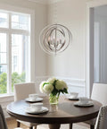Open Globe Chandelier 21 Inch 4-Light Modern Sphere Orb Pendant in Brushed Nickel Finish hangs over a dining table.