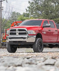 Red Ram 2500 truck equipped with Steering Box Brace For Ram 2500 3500 4WD 2017 To 2026 Bolt On Frame Support in outdoor setting