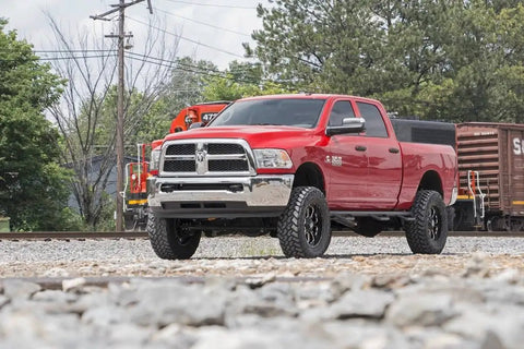 Red Ram 2500 truck equipped with Steering Box Brace For Ram 2500 3500 4WD 2017 To 2026 Bolt On Frame Support in outdoor setting