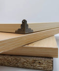Heavy Duty Antique Corner Protectors 48 Pack Vintage Bronze Furniture Edge Guards on wooden boards in stacked arrangement.