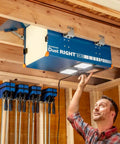 Compact Ceiling Air Filtration Unit With Heavy Duty Triple Stage Filters For Tight Garages And Low Ceilings, installed above a workshop.