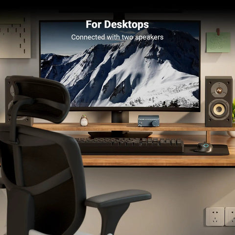 Desktop setup with V1.0G 2 Channel Class D Mini Stereo Amplifier for Home Speakers, connected to monitors, showing snowy mountain image.
