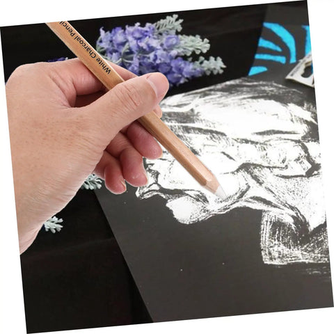 Hand using 4 Pack White Charcoal And Graphite Pencils Set For Art Drawing Dope Sketching Shading Blending Journaling Illustrations Pro Grade Quality For Realistic Artwork on black paper.