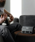 Person playing guitar with Beast 10W Mini Guitar Amp For Bedroom Practice Portable All-In-One Bluetooth Amp on table